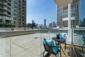 a balcony with a table and chairs on a building at WOW! 1 Bed & Sofa Bed! 10-min walk to Dubai Mall in Dubai