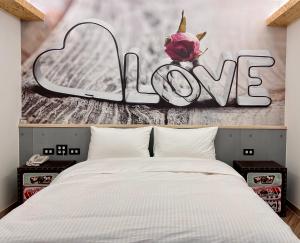 A bed or beds in a room at Good Time Boutique Hotel