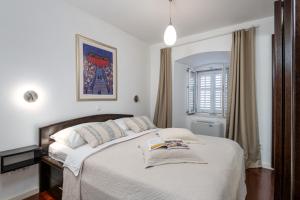 a bedroom with a large bed with white sheets at Villa Mirabilis, stunning superior villa, Dubrovnik Old Town in Dubrovnik