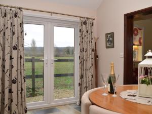 a sliding glass door with a view of a field at 1 bed in Bradford-on-Avon 58771 in Erlestoke