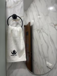 a towel hanging in front of a mirror in a bathroom at Aygestan plaza apartment 5 in Yerevan