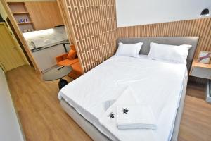a small bedroom with a bed with white sheets at Aygestan plaza apartment 5 in Yerevan