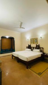 a bedroom with a large bed and a window at Heritage Resort Bikaner in Bikaner
