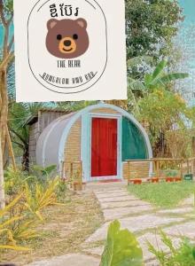 a sign with a teddy bear in front of a tent at The Bear Bungalow in Kampot