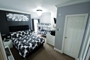 a bedroom with a bed and two bunk beds at Rossall Guest House -Ideal For Families & Couples in Blackpool +79 photos
