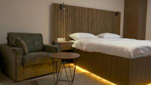 a bedroom with a bed and a chair and a table at Vicolo Otel in Istanbul