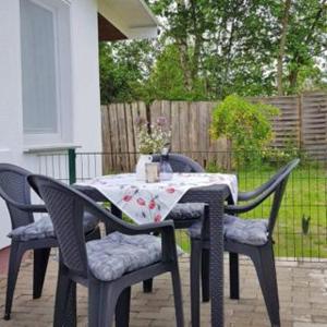 a table with two chairs and a tablecloth on a patio at Großer Gartenbungalow Nr 3 mit Terrasse - Strandvogtei Sellin in Ostseebad Sellin