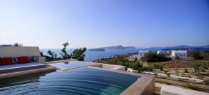 a pool with a couch and a view of the ocean at 11:11 By Potnia in Akrotiri +95 photos