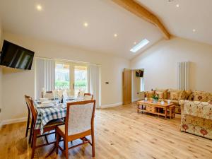 a living room with a table and a couch at 3 Bed in Wroxham 83034 in Worstead