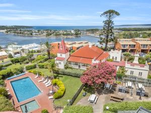 an aerial view of a house with a swimming pool at Munns Tower House in Merimbula