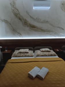 A bed or beds in a room at Boglárka Vendégház