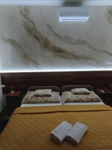 A bed or beds in a room at Boglárka Vendégház