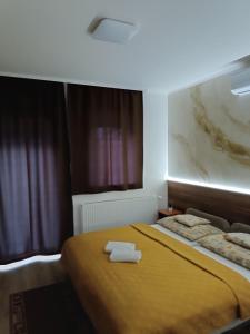 A bed or beds in a room at Boglárka Vendégház