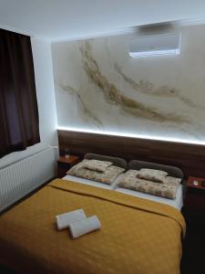 A bed or beds in a room at Boglárka Vendégház
