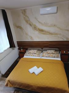 A bed or beds in a room at Boglárka Vendégház