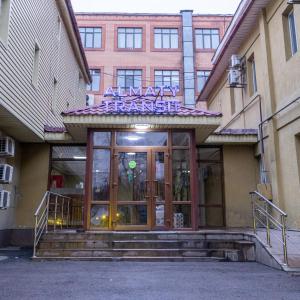 une entrée à un bâtiment avec un panneau sur celui-ci dans l'établissement Алматы Транзит №1, à Turksib