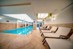 a hotel pool with lounge chairs and a swimming pool at Mountain Lake Hotel in Smolyan