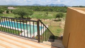 een balkon van een huis met een zwembad bij Samburu Dik-Dik House & Susuk Self-catering Cottage in Archers Post