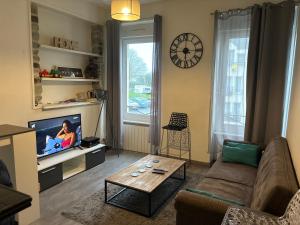a living room with a couch and a coffee table at Sweetie Flat in Cherbourg en Cotentin