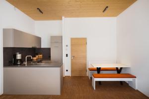 a kitchen with a table and a bench in a room at St Michael Alpin Retreat in Matrei am Brenner +41 photos
