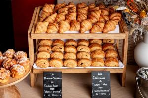 a display of croissants and donuts in a bakery at Canopy By Hilton Paris Trocadero in Paris