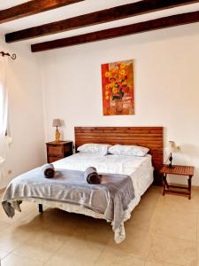 a bedroom with a bed with two hats on it at Beach House Valleniza in Vélez-Málaga