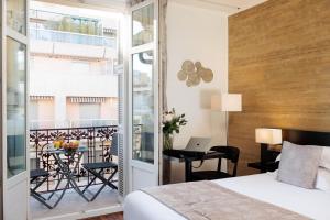 a bedroom with a bed and a balcony with a desk at Best Western Plus Hôtel Massena Nice in Nice +37 photos