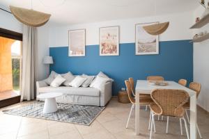 a living room with a couch and a table at Villaggio Perlacea - Your House in Sardinia in Golfo Aranci