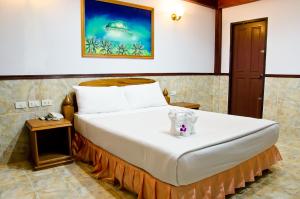 מיטה או מיטות בחדר ב-Kata Palace Phuket
