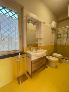 a bathroom with a sink and a toilet at Villa Aura in Torre del Greco