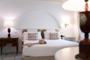 a bedroom with a bed with a teddy bear on it at Masseria Il Melograno in Monopoli