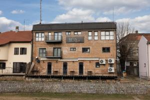 an old brick building with a sign on it at RIVA sleep & chill in Valjevo