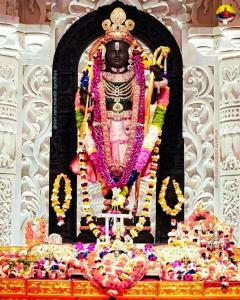a large statue of a god in a temple at Ramam hotel by Naavagat Ayodhya in Ayodhya