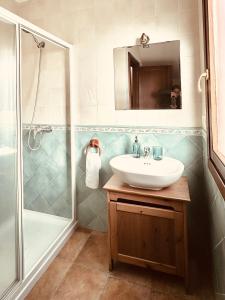 a bathroom with a sink and a shower at Los Castros Apartamentos Rurales B in Llames de Pría