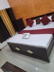 two beds in a room with a large bed at Ramam hotel by Naavagat Ayodhya in Ayodhya