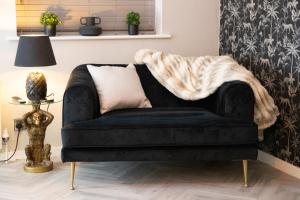 a couch with a blanket on it in a living room at 2 Bedroom Property with Free Parking close to Leeds City Centre in Leeds