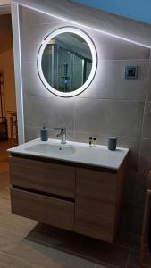 a bathroom with a sink and a mirror at Casa da Póvoa in Seia