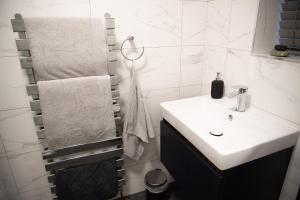 a white bathroom with a sink and a shower at 2 Bedroom Property with Free Parking close to Leeds City Centre in Leeds +33 photos