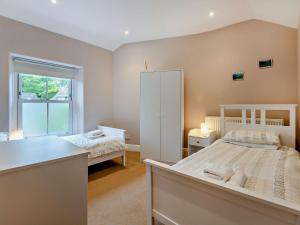 a bedroom with a white bed and a window at 3 Bed in Bamford PK838 in Bamford