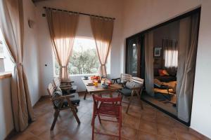 a living room with a wooden table and chairs at Cozy country home with heated outdoor pool in Šibenik