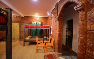 a room with two chairs and a bunk bed at Pepper Paradise by StayApart in Dandeli