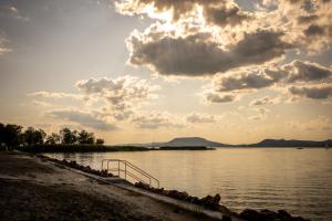 a view of a body of water with a cloudy sky at Love House Balatonboglár Apartman in Balatonboglár