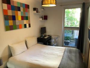 a bedroom with a bed with a desk and a window at Best Apartment in the Center of Berlin with Big Terrace in Berlin