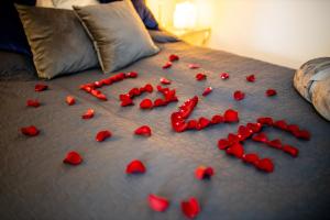a bunch of red hearts on a bed at Love House Balatonboglár Apartman in Balatonboglár