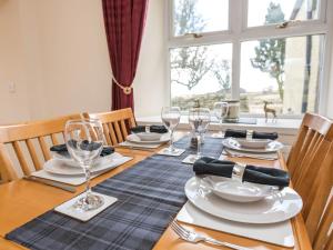 a table with plates and wine glasses on it at 2 Bed in Edzell CA300 in Edzell