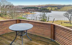 a table on a wooden deck with a view of a lake at Amazing Apartment In Sandnes With 2 Bedrooms And Wifi in Bråstein