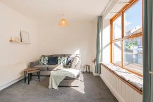 a living room with a couch and a window at The Space by Afan Valley Escapes in Port Talbot