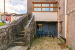 a group of chairs sitting outside of a building at The Space by Afan Valley Escapes in Port Talbot