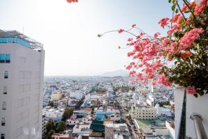 a view of a city with pink flowers at LeMore Hotel Nha Trang in Nha Trang