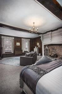 a large bedroom with a bed and a couch at The Pied Bull in Chester